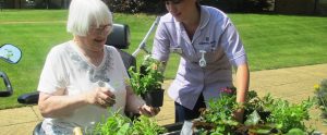 resident gardening with a member of our staff