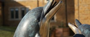 A close up of the Dolphin water feature at Godswell PArk Care Home at Bloxham in Oxfordshire